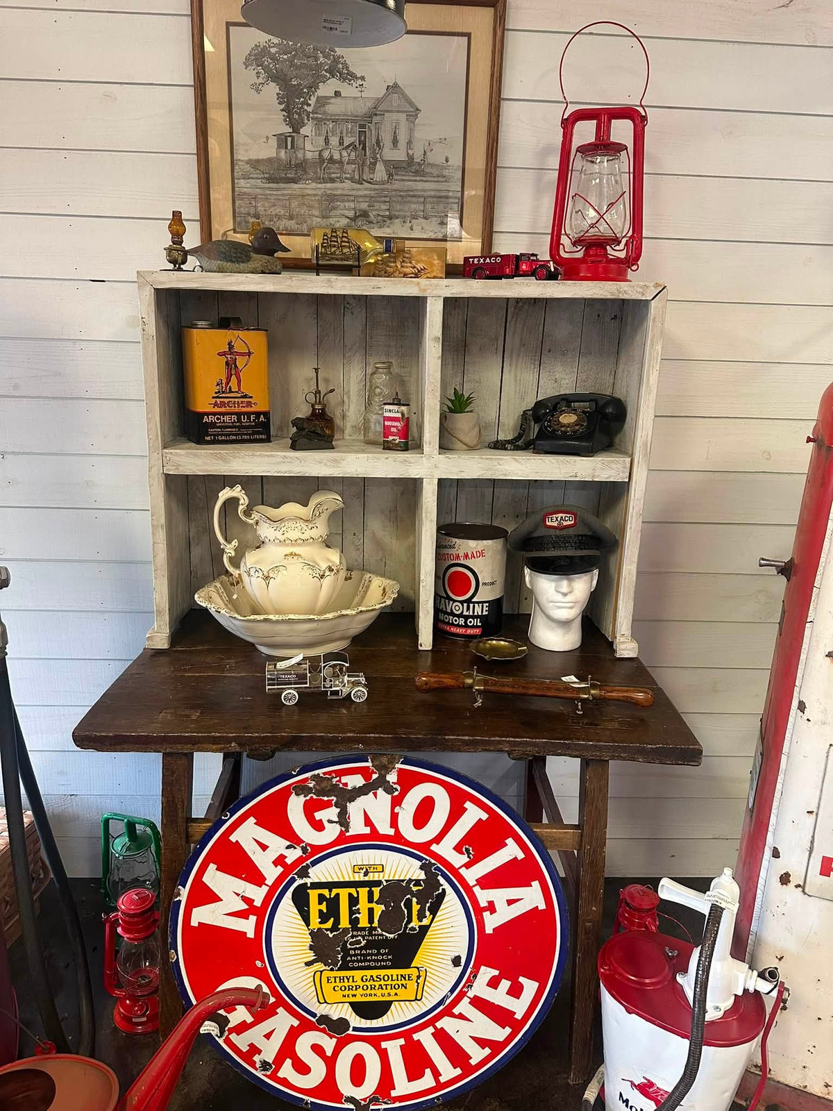 Styled hutch with Magnolia gasoline sign and stoneware